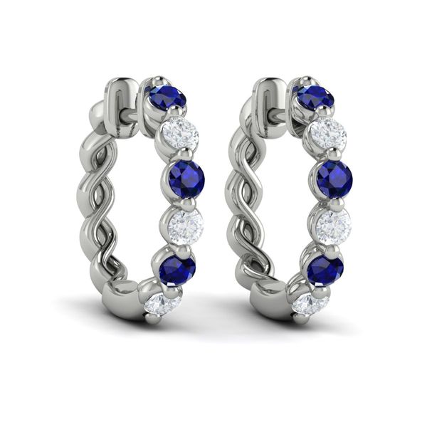 The most stunning sapphire hoops ever!! These earrings are set in 14 kt white gold and feature 3 round sapphires and 3 round 