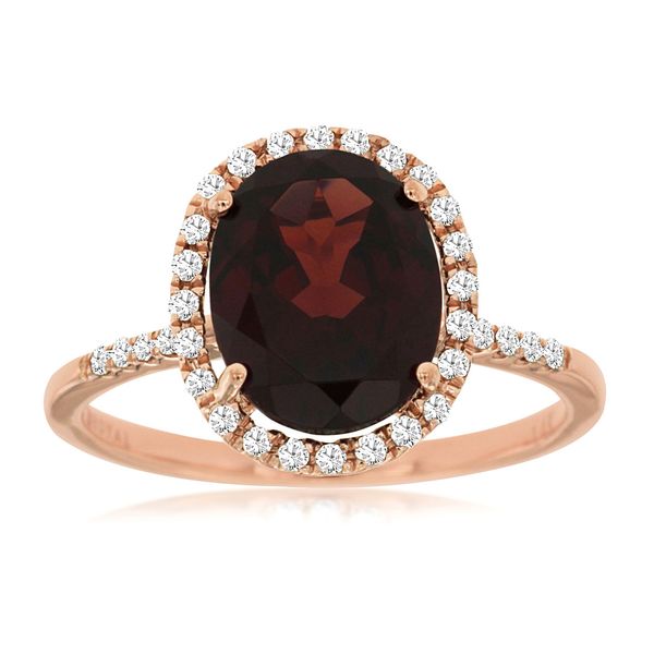 This lovely 14 kt rose gold ring features a 2.75 carat oval garnet surrounded by a halo of diamonds  and the diamonds continu