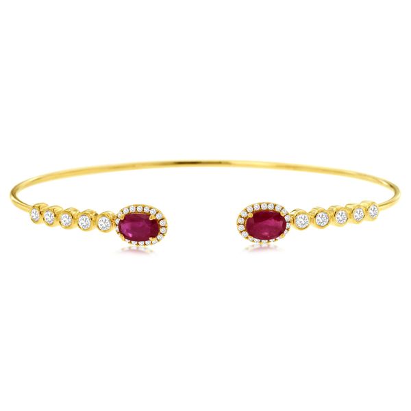  This one is meant for ROYALTY! This open bangle 14 kt yellow gold bracelet features 2 oval ruby  stones for a total of 1.12 